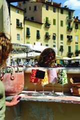 A tourist browsing souvenirs on Piazza dell'Anfiteatro, Lucca