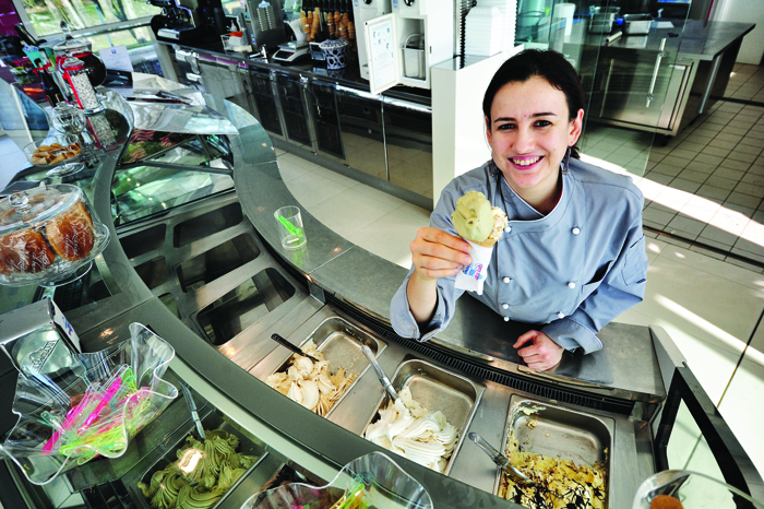 Tutor Luisa Elena Fontana poses in the gelateria shop at the Carpigiani headquarters in Anzola nell'Emilia, near Bologna. Luisa Elena, who is a former student of the Carpigiani Gelato University, now supervises the students in their fourth week of course, during their practical training in an exact replica of a gelateria which is open to the public.