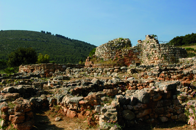 The entrance to the nuraghe di Palmavera, located just outside the town of Alghero. The site is one of the largest in the region and comprises a ruined palace  dating from the 14th and 13th centuries BC (pictured), surrounded by fifty circular huts.