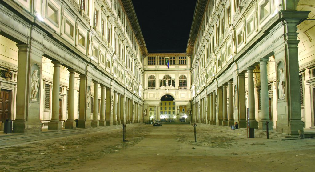 The Uffizi museum in Florence, Italy, by night. Faces blurred by long exposure.