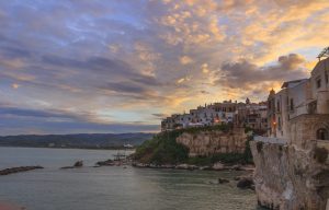 View of the historic center of Vieste at sunset during a summer evening.