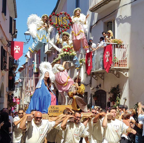 The procession, being carried by a team of bearers