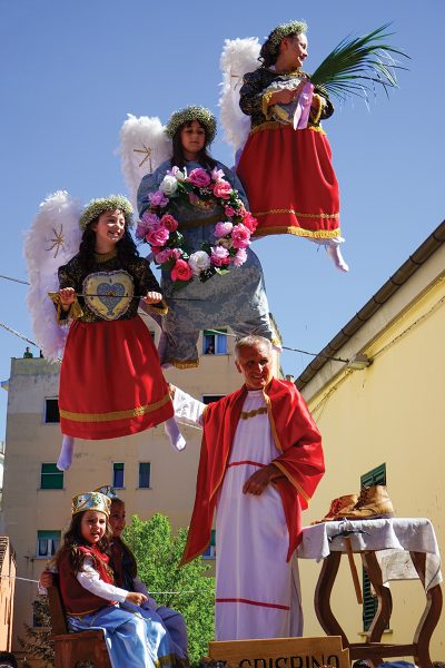 Three children in costume, suspended in the air on a machine