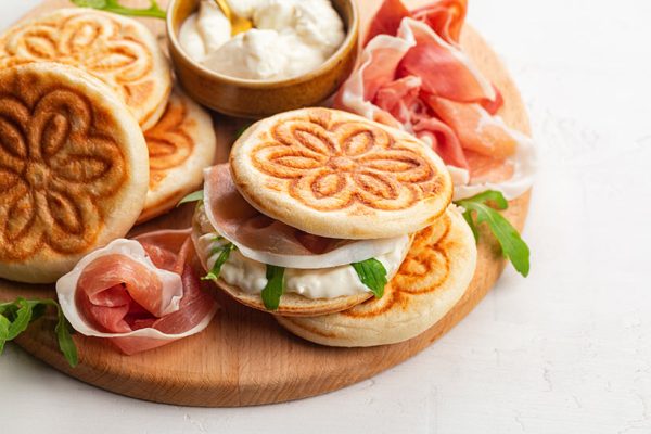 round flatbreads with a flower pattern, filled with cured ham and cheese