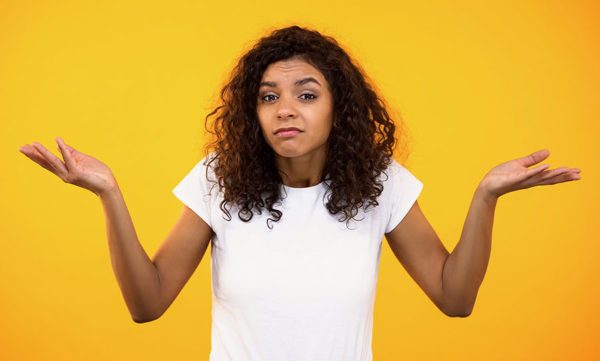 Woman shrugging to show Italian boh meaning