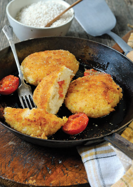 rice cakes in pan with mozzarella and tomato middle