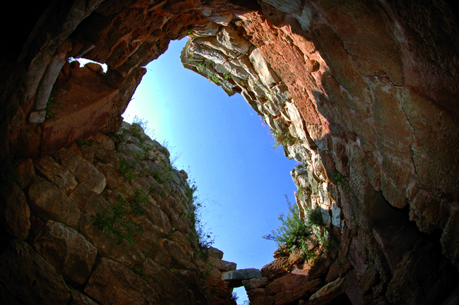 The inside of the nuraghe di Palmavera, located just outside the town of Alghero. The site is one of the largest in the region and comprises a ruined palace  dating from the 14th and 13th centuries BC (pictured), surrounded by fifty circular huts.