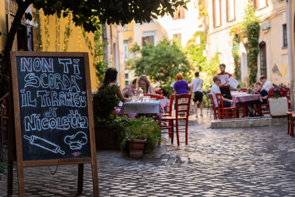 Eating out in Trastevere with restaurant sign that says "non di scorda il tiramisu di nicoletta"