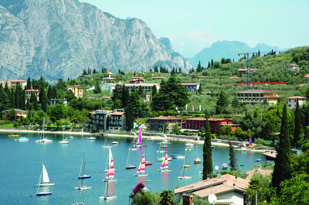 Sailing boats on lakeside with mountains