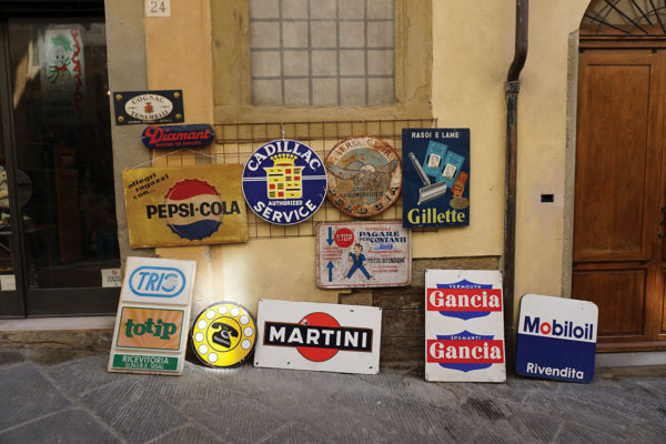 Vintage advertising signs for sale at the Arezzo antiques market