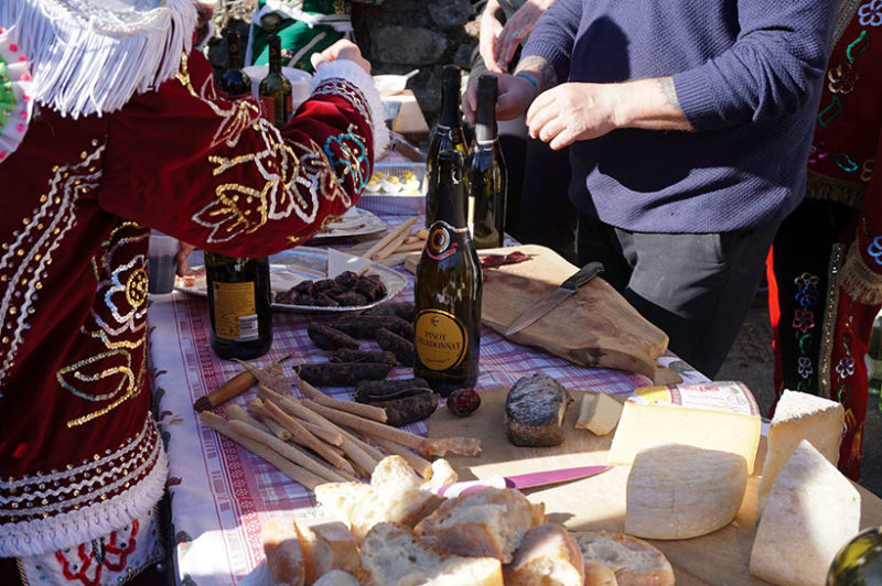 Table of cheese, wine, and other foods at carnival