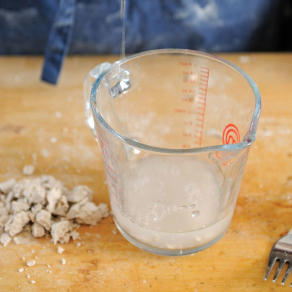Step 1: mixing the yeast and the sugar in the water