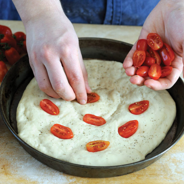 Step 7: placing cherry tomato halves into the dough