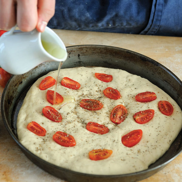 Step 8: The rested focaccia gets a sprinkle of herbs and salt, and another drizzle of oil