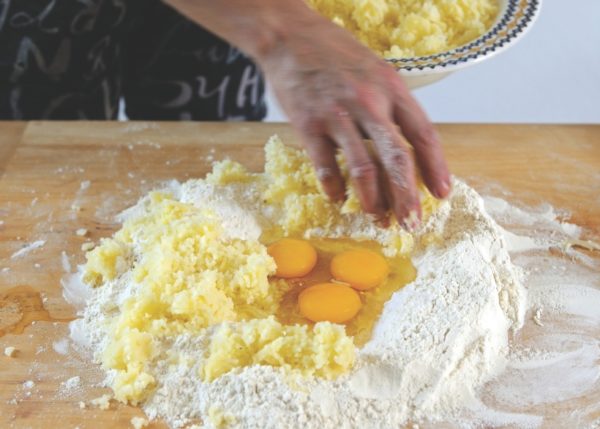 mixing mashed potato into eggs and flour