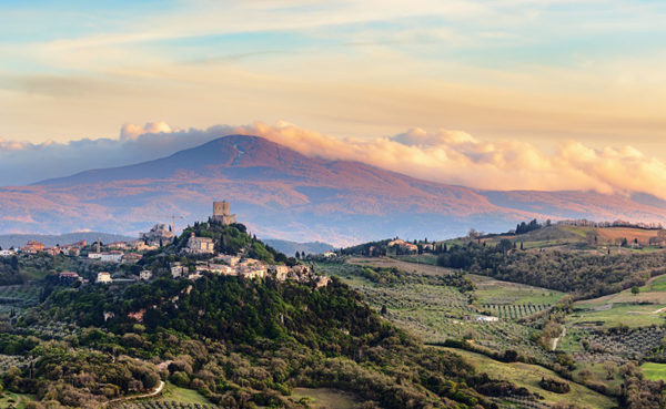 View over Castiglione d'Orcia in evening light in the Val d'Orcia in Tuscany, Italy, with Monte Amiata in the background