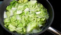cabbage being boiled in a pan