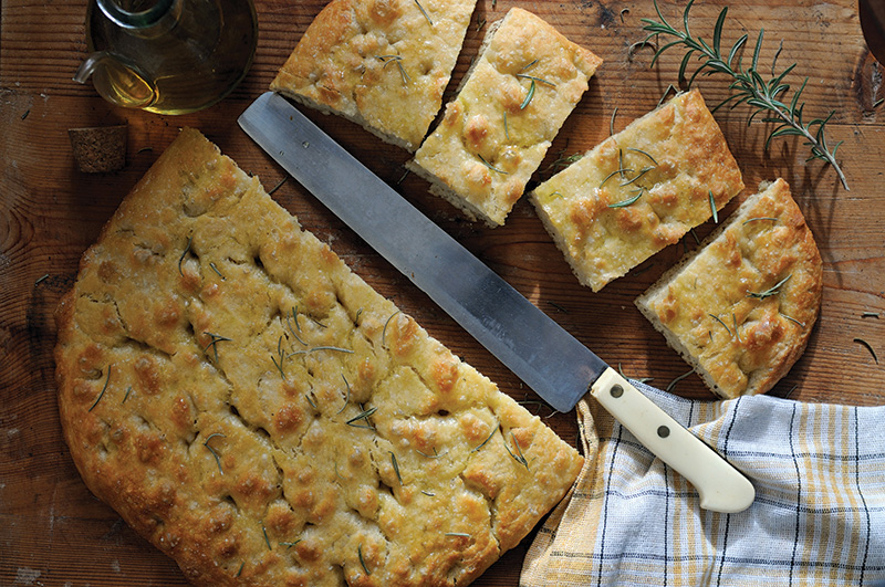 sliced focaccia on wooden table