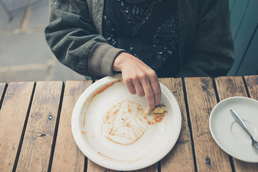 clearing sauce from a plate with a piece of bread