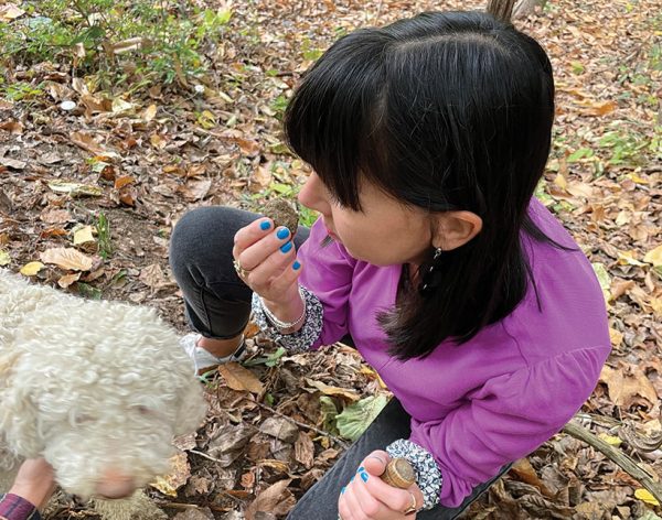 Kate Wickers sniffs a black truffle found by Luna