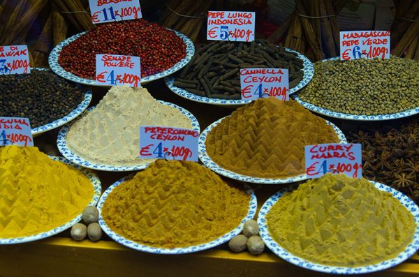 piles of herbs and spices in a shop window