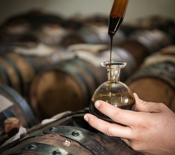 balsamic vinegar being put into glass jar