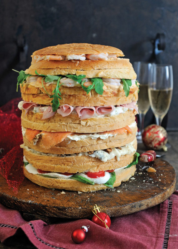 layered gastronomic panettone with cream cheese, salmon, rocket, ham and other savoury fillings