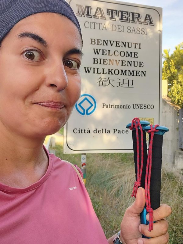 Val Nicastro with 'welcome to Matera' sign at the end of the via peuceta