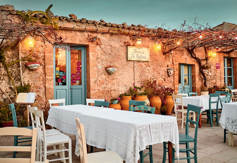 iew of a typical restaurant in Marzamemi at sunset