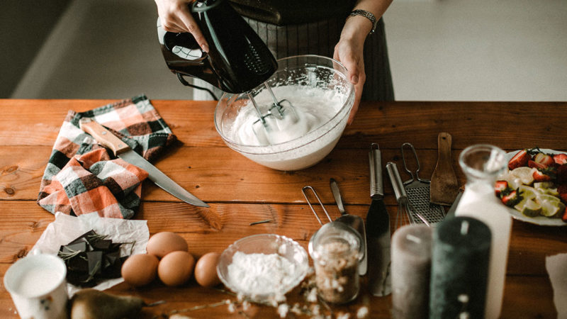 woman making italian dessert recipes with electric mixer in rustic kitchen