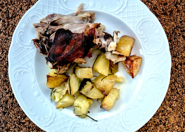 meal of suckling pig pork, potatoes and vegetables