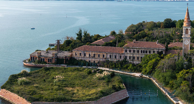 Aerial view of the plagued ghost island of Poveglia in the Venetian lagoon, opposite Malamocco along the Canal Orfano near Venice, Italy.