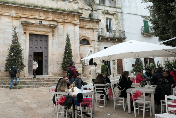 People sitting at outdoor cafe seating in festive village