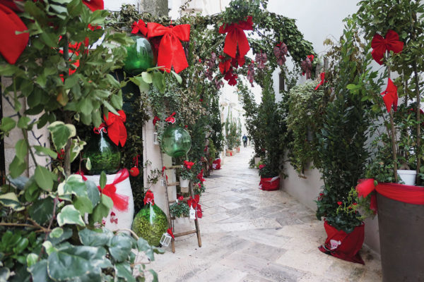 White lane with thick green and red decorations - day time