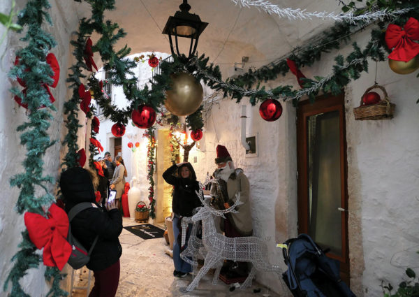 Animatronic santa with saxophone in decorated Locorotondo passageway