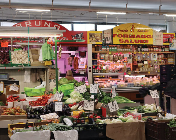 Rome market stalls selling cheese, meats, and veggies. 