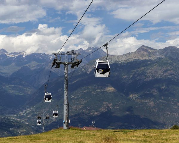 The Aosta-Pila gondola lift in summer arriving at Pila