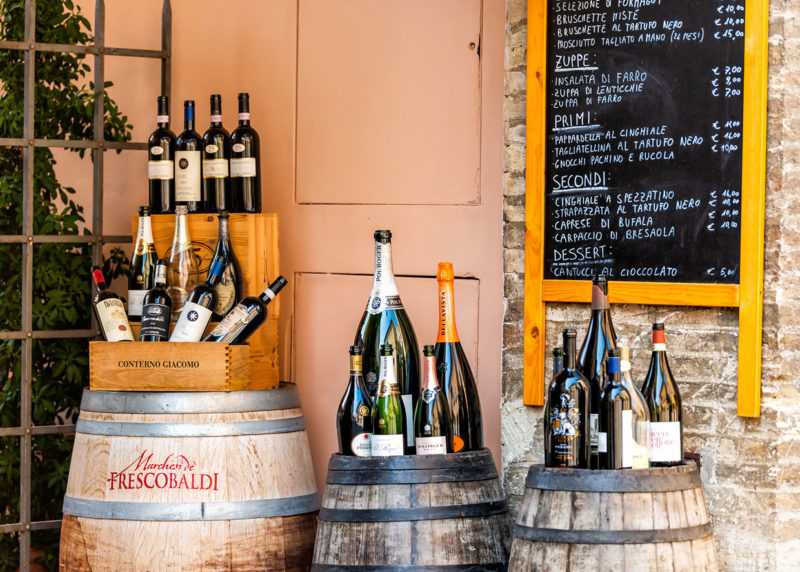 various wines outside small village restaurant store with food menu in umbria nr Assisi