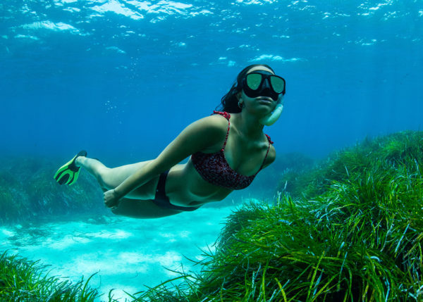 Woman explores the depths of the Mediterranean snorkelling