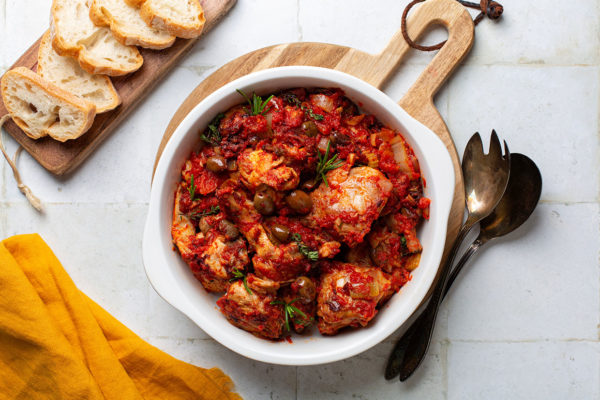 Italian rabbit stew cooked with white wine, tomatoes and olives, thyme and rosemary. Coniglio all'ischitana. Ischia dish.