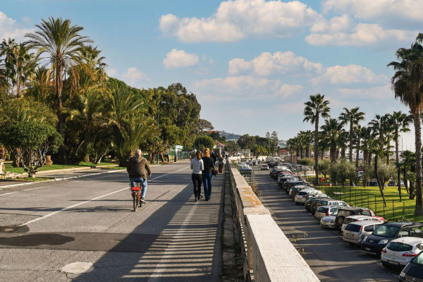 People walking and cycling on the bike path that connects the coastal cities of Ospedaletti and San Lorenzo