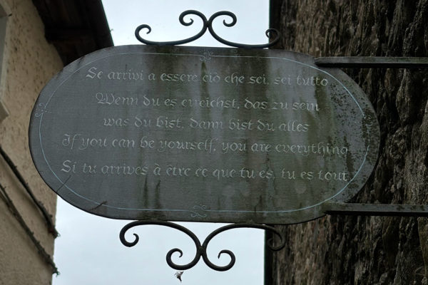 sign with inspirational quote in multiple languages