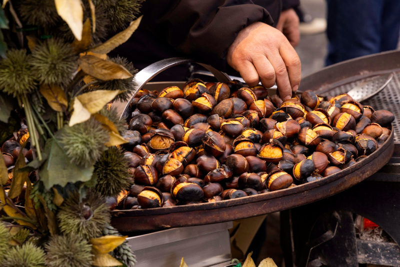 Chestnuts roasting in street food pan in Italy, Vallerano